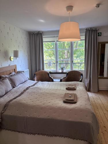 a bedroom with a large bed and a large window at Minnesberg Bed & Breakfast in Trelleborg