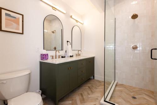 a bathroom with a toilet and a sink and a shower at Modern condo with town and mountain views in Evergreen