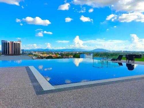 a swimming pool on the roof of a building at Regatta at Kozi Square Kuching in Kuching