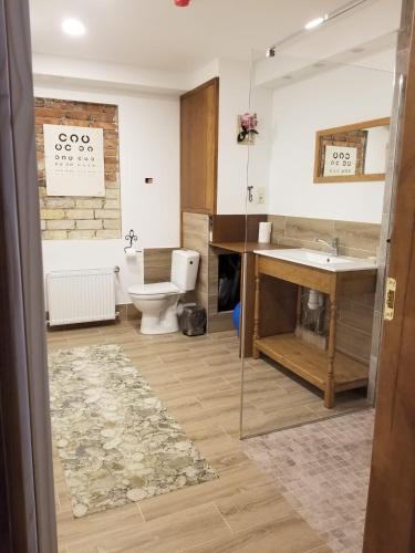a bathroom with a toilet and a sink at A&S Vidugiris in Jurbarkas