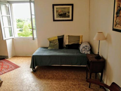 a bedroom with a bed and a window at 2-room apartment in Clamecy