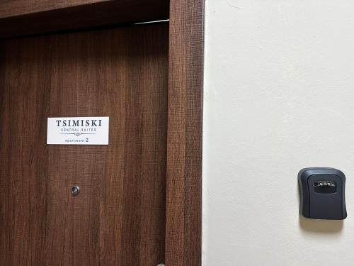a sign on a wooden door with a sign on it at Tsimiski Central Suites in Thessaloniki