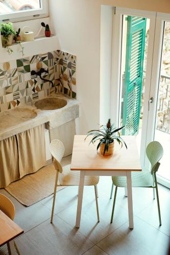 a table and chairs in a room with a window at La Terrazza di Maddalena in Cisano sul Neva