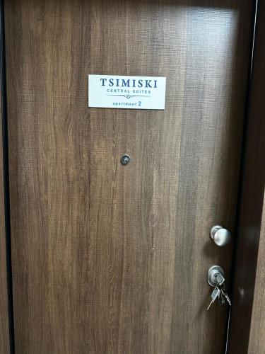 a sign on a wooden door with a sign on it at Tsimiski Central Suites in Thessaloniki