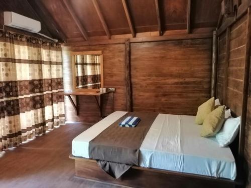 a bedroom with a bed in a wooden room at Malwathu Oya Forest Garden in Anuradhapura