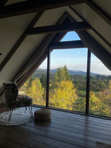 a room with a window with a view of the mountains at Javor Holiday House in Žumberak