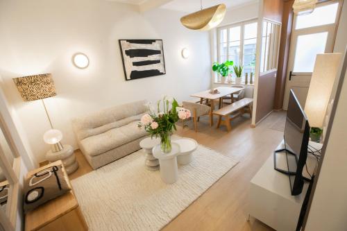 a living room with a couch and a table at Maison Lumière Arras in Arras