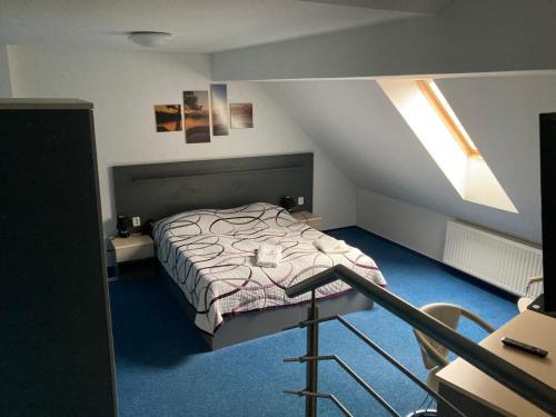 a bedroom with a bed in a attic at Penzion Grasel in Nové Syrovice