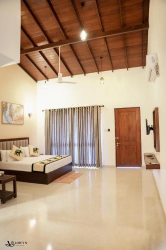 a bedroom with a bed and a large window at Velowyn Ella in Ella