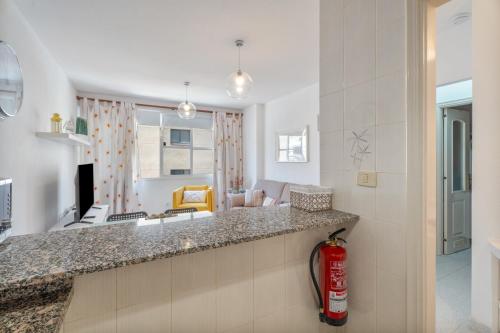 a kitchen and living room with a fire extinguisher at Casa Cabana in El Médano