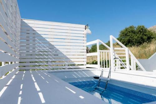 a swimming pool next to a white building with at Mary Luxury House in Émbonas