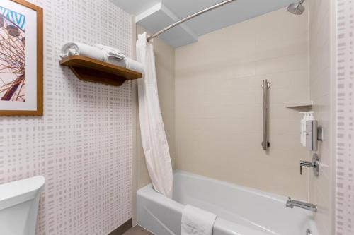 a bathroom with a white tub and a toilet at Hampton Inn Chicago-Gurnee in Gurnee
