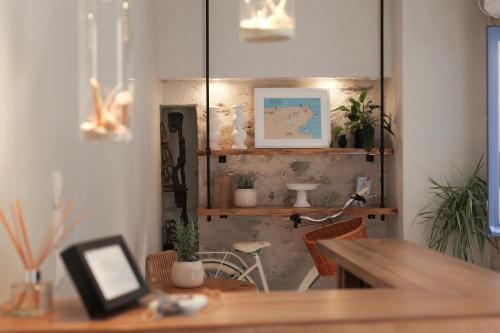 a room with a table and a bike in a room at BOĒM Boutique Hotel Lefkada in Lefkada
