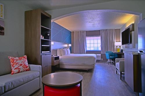 a hotel room with a bed and a living room at Comfort Inn & Suites Sierra Vista near Ft Huachuca in Sierra Vista