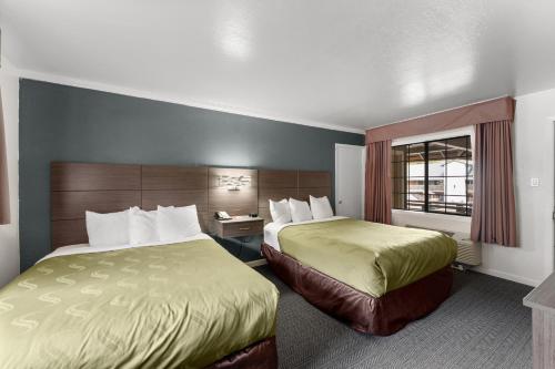a hotel room with two beds and a window at Econo Lodge Inn & Suites Heavenly Village Area in South Lake Tahoe