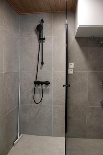 a bathroom with a shower with a glass door at Spot Apartments Airport Premium in Vantaa