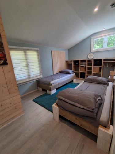 a bedroom with two beds and a window at Domki Spore in Spore