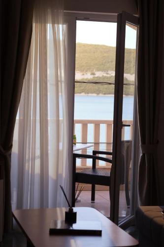 a room with a table and a view of a balcony at Villa Ancora in Neum