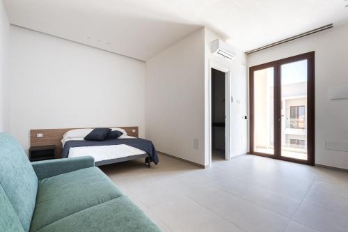 a living room with a bed and a couch at Aura - Stagnone Apartments in Marsala