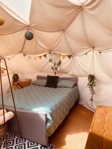 a bedroom with a bed in a tent at Ebb Dome at Estuary Escapes in Kingsbridge