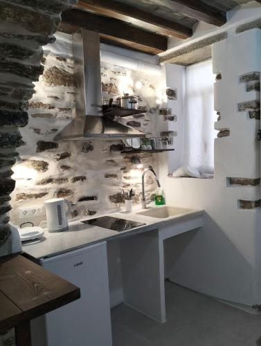 a kitchen with a sink and a counter top at Μαγαζάκι in Tripótamos