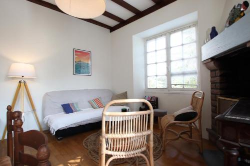 a living room with a couch and a chair at Etche alabena - 2 in Ainhoa
