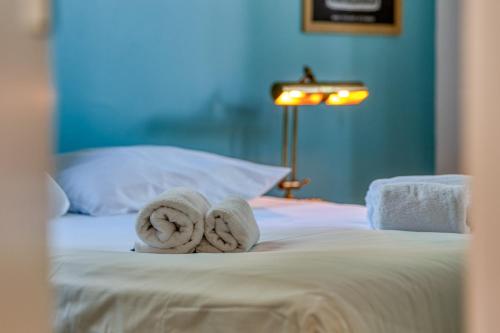 a bed with towels on top of it at Villa des Dunes Beach 600m Private Jacuzzi Pine Forest Nature Sleeps 8 in Brem-sur-Mer