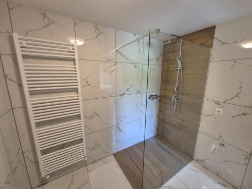 a bathroom with a shower with a glass door at Apartma Markelj in Radovljica