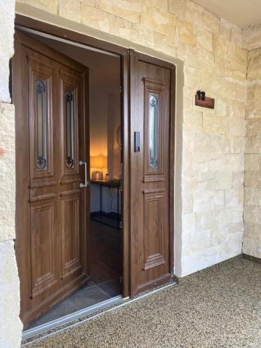 an open wooden door in a stone wall at Le AVRA MONTIS in Galata