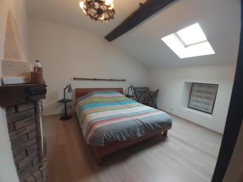 a bedroom with a bed in a attic at Maison cosy en pierre parking centre in Vittel