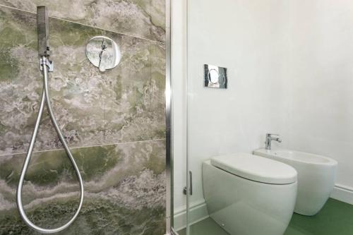 a bathroom with a shower and a toilet and a sink at Monforte's Etna Loft in Piedimonte Etneo