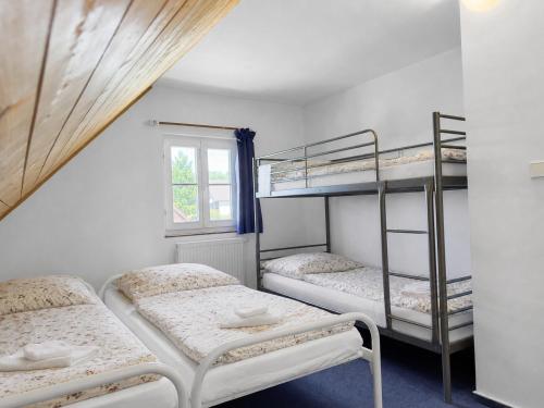 a room with two bunk beds and a window at Chata Křemenka in Lauterwasser