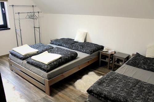 a bedroom with two beds and a table at Oščadnica, Tadorka in Čadca