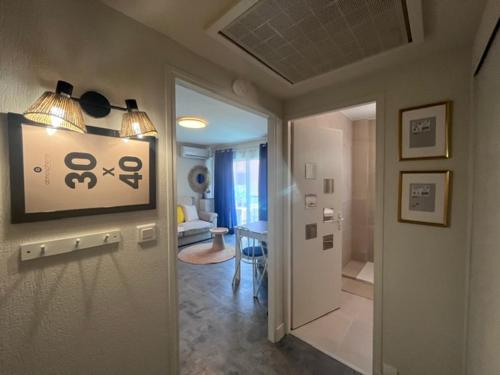 a hallway with a living room and a room with a table at Philoxenia in Bandol