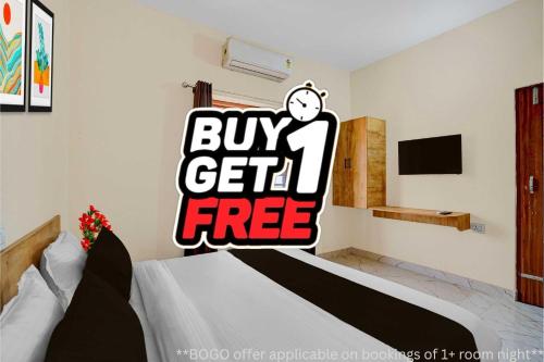 a bedroom with a bed with a buy get free sign at Super Hotel O Dharampur Crossway in Mājra