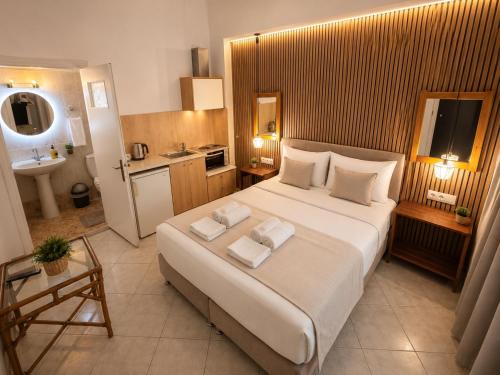 a bedroom with a large bed and a bathroom at Atlantis Hotel in Agios Nikolaos