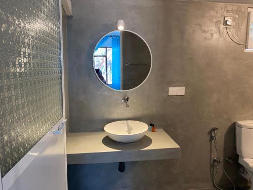 a bathroom with a sink and a mirror at Vibration Nilaveli in Trincomalee