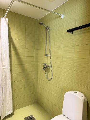 a bathroom with a shower and a toilet at River Apartment in Pärnu