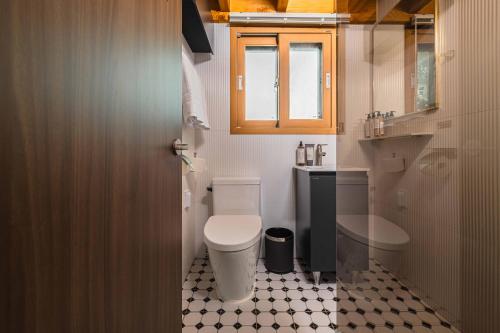 a small bathroom with a toilet and a sink at Luxury Hanok Blue Serenity in T'ongjin