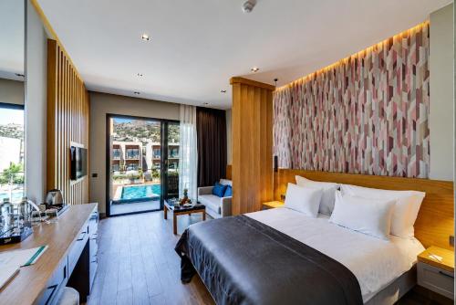 a hotel room with a large bed and a desk at Celeste Bella Luxury Hotel & Spa in Bodrum City