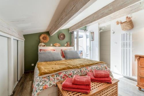 a bedroom with a large bed and green walls at Mon Cabanon Roquemaure in Roquemaure