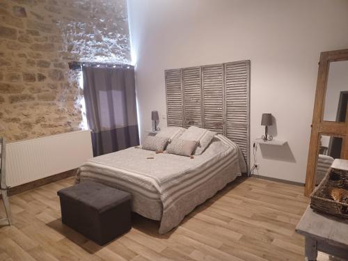 a bedroom with a large bed and a window at LA GRANGE DU RIAL in Bournazel
