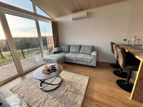 a living room with a couch and a table at Fernblick- Sauna- WLAN- Haus 2 in Neheim-Hüsten