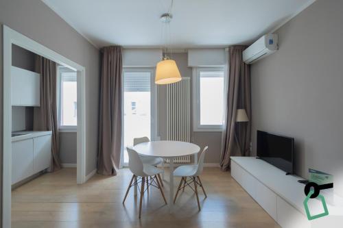 a living room with a table and a couch at Hotiday Padova San Giuseppe in Padova