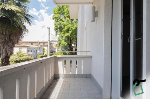 a balcony with a view of a palm tree at Hotiday Padova San Giuseppe in Padova