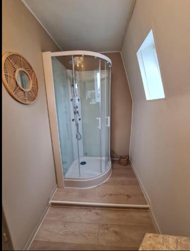 a bathroom with a glass shower in a attic at Grand gîte 150 m2 - 4 chambres - Salle de jeux avec billard et fléchettes in Péronne