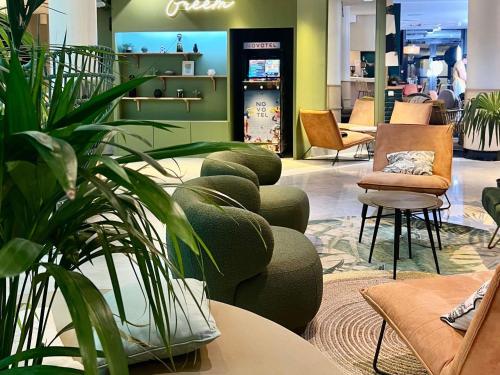 a store with a bunch of plants and chairs at Novotel Paris Pont De Sevres in Sèvres