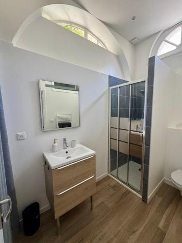 a bathroom with a sink and a mirror and a shower at Maison Delayant in La Rochelle