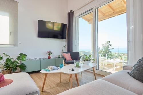 a living room with a couch and a table at Gaea Loft Villa - 1st Floor in Kokkini Khanion
