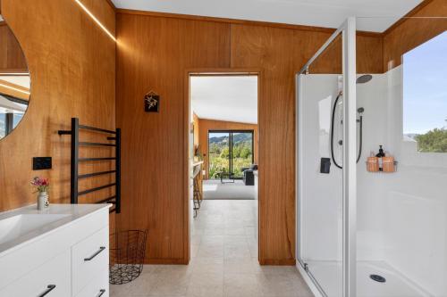 a bathroom with a shower and a sink at Relaxing Getaway in Pohara in Pohara